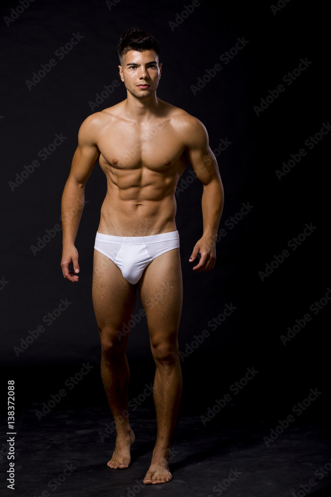 Handsome muscular young man posing in the studio