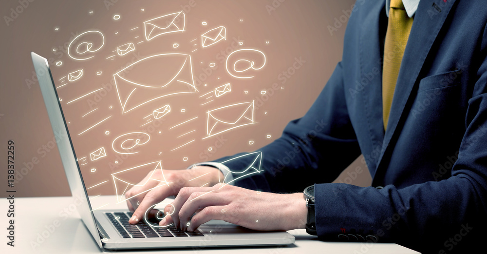 Sending client news letters on laptop Sending client news letters on laptop