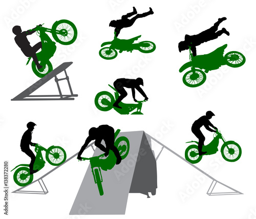 Stunt show on a motorcycle and snowmobile. Silhouette of stunt man.