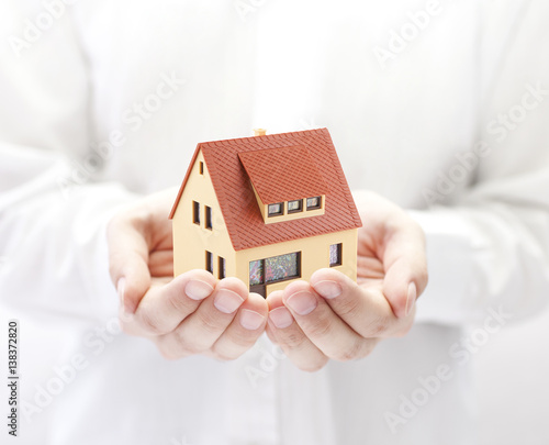 Small toy house in hands