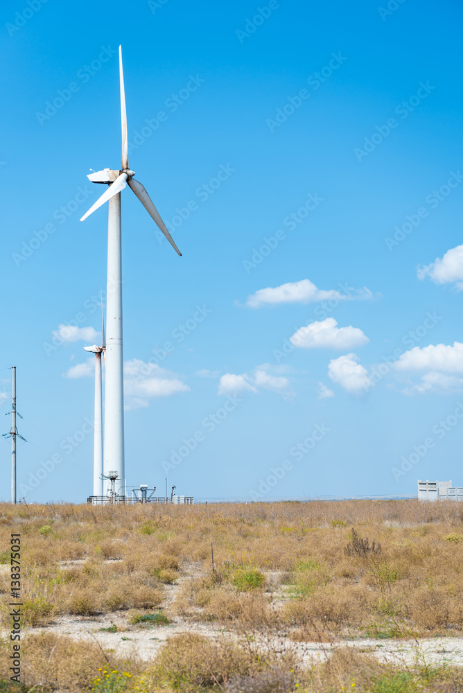 Wind Turbine for alternative energy with power poles. Eco power concept Wind Turbine for alternative energy with power poles. Eco power concept