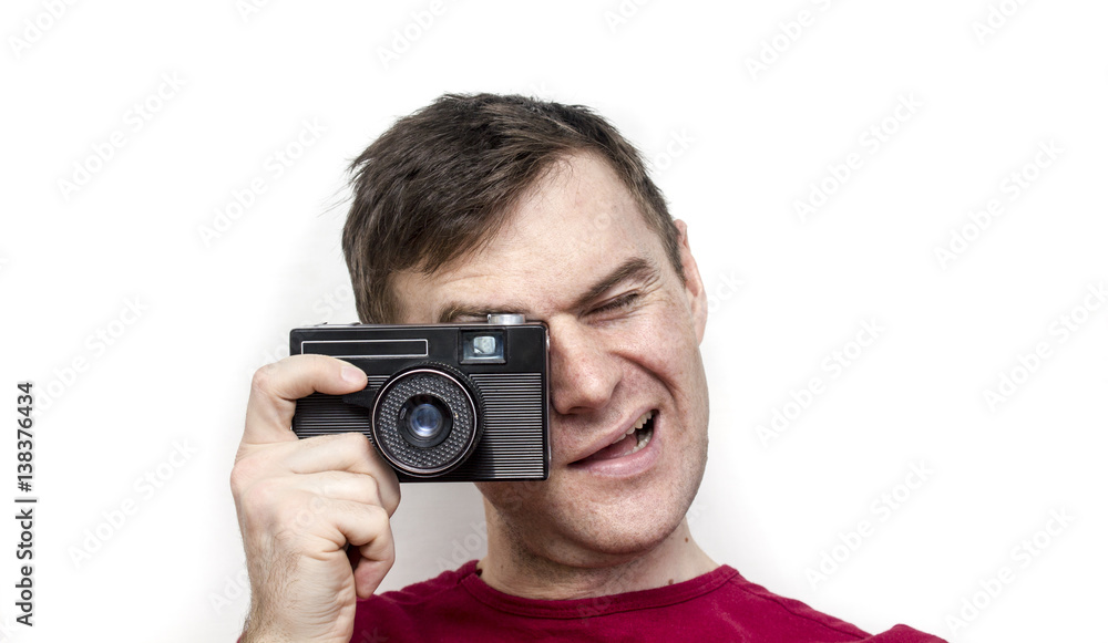 Man in a red shirt with old camera, white background Man in a red shirt with old camera, white background