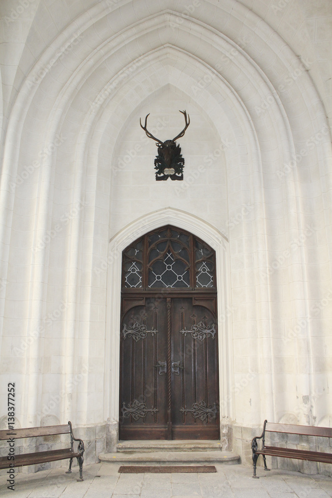 Old church doors with trophy below.