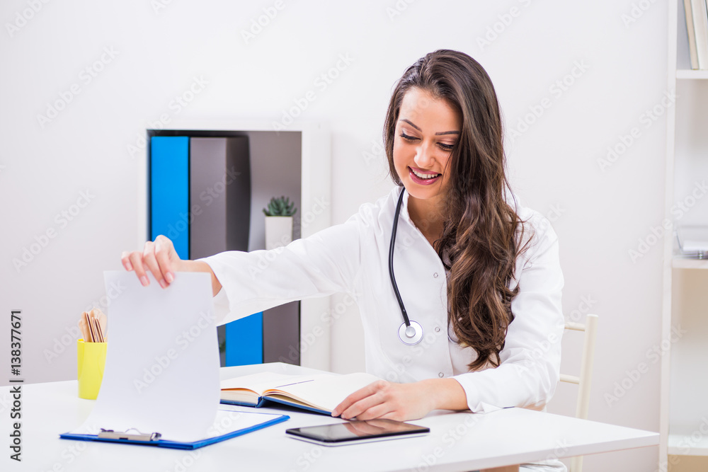 Beautiful female doctor working at her office. Beautiful female doctor working at her office.