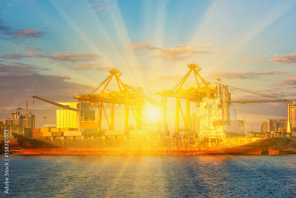 container ship in import export and business logistic.By crane , Trade Port , Shipping.Tugboat assisting cargo to harbor.Aerial view. container ship in import export and business logistic.By crane , Trade Port , Shipping.Tugboat assisting cargo to harbor.Aerial view.