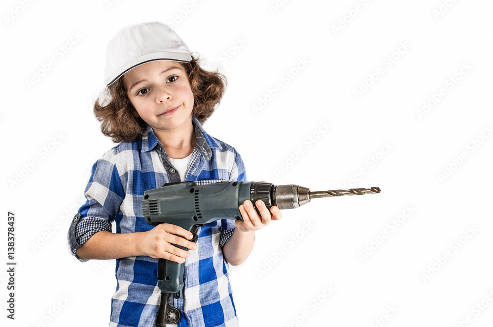 Curly boy in overalls holding a hammer. White background. Curly boy in overalls holding a hammer. White background.