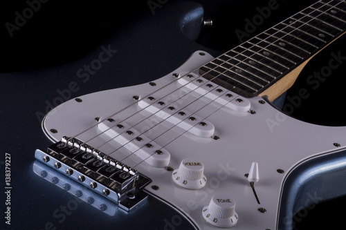 narrow cut of an electric guitar in black and white