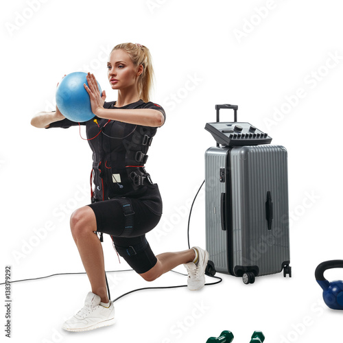 EMS fitness woman doing lunge exercise with ball