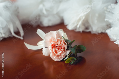 fiances wedding buttonhole made of beige rose photo