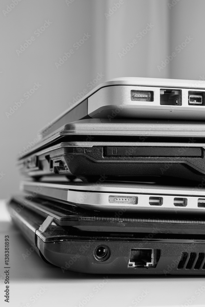The different laptops placed on a table on a roll. Vertical indoors shot. The different laptops placed on a table on a roll. Vertical indoors shot.