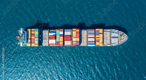 container ship in import export and business logistic.By crane ,Trade Port , Shipping.cargo to harbor.Aerial view.Top view. photo