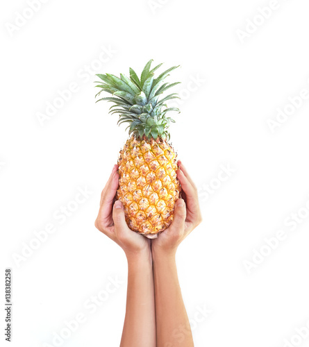 A pineapple.Pipe Pineapple in hand studio white background. Fruit Pineapple. Arms. Asia.