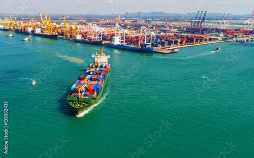container ship in import export and business logistic.By crane ,Trade Port , Shipping.cargo to harbor.Aerial view.Top view. © MAGNIFIER