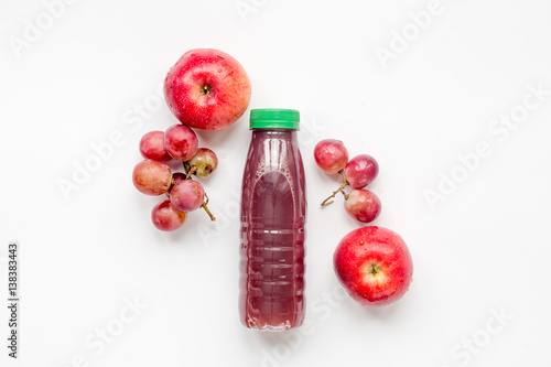 plastic bottles with fruit drinks on white background top view mock-up