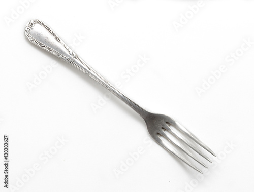 Fototapeta Old metal fork isolated on a white background.