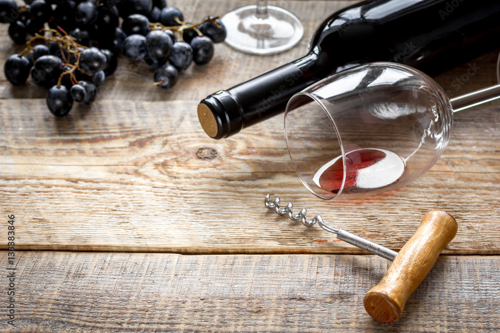 restaurant set with wine bottle and grape on wooden background