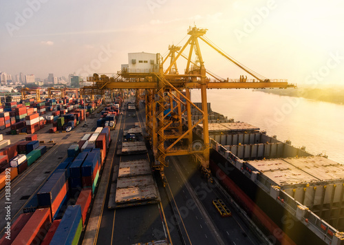 container ship in import export and business logistic.By crane ,Trade Port , Shipping.cargo to harbor.Aerial view.Top view.