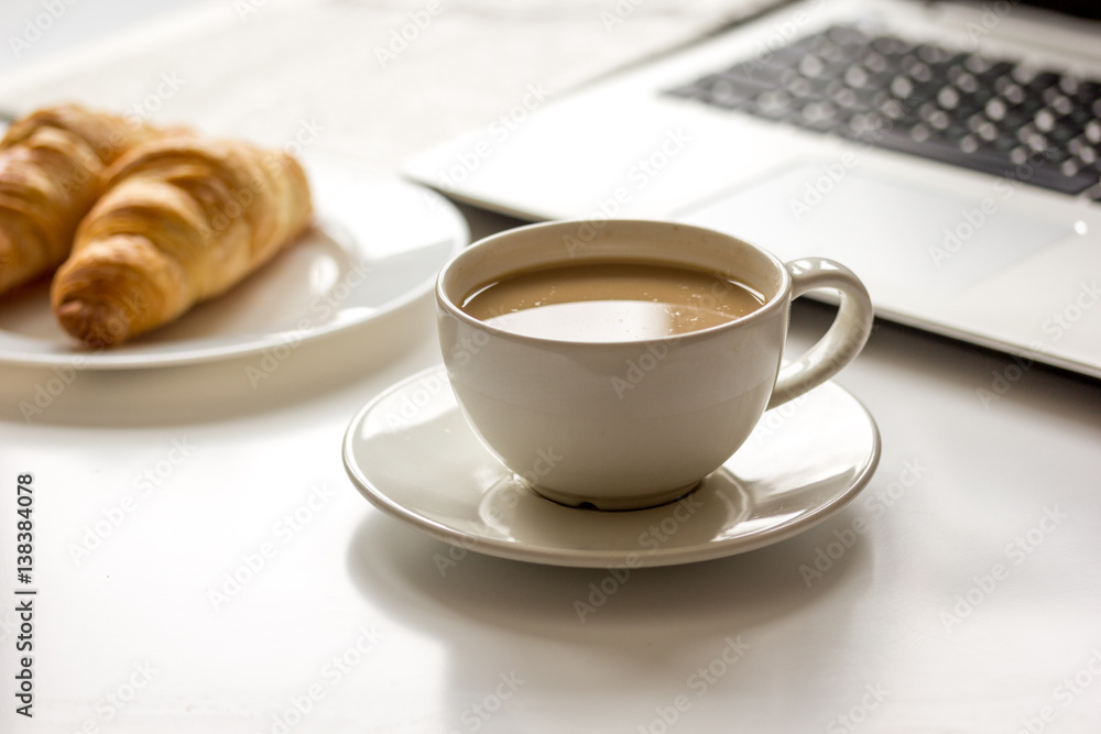 Office breakfast with laptop on white desk Office breakfast with laptop on white desk