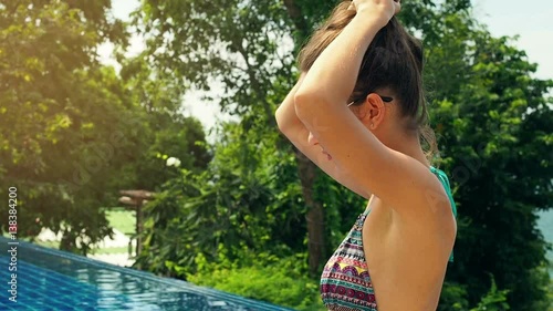 Girl let down her hair. at luxuary swimming pool, the Action in slow motion