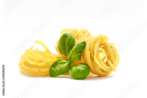 Italian pasta with basil isolated on white background