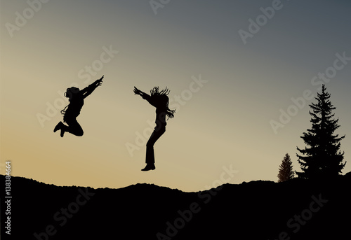 Silhouette of two jumping girls with long hair on the wilderness. Sunset.