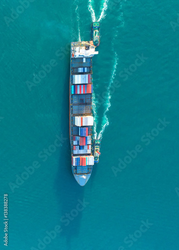container ship in import export and business logistic.By crane ,Trade Port , Shipping.cargo to harbor.Aerial view.Water transport.International.Shell Marine.Top view.