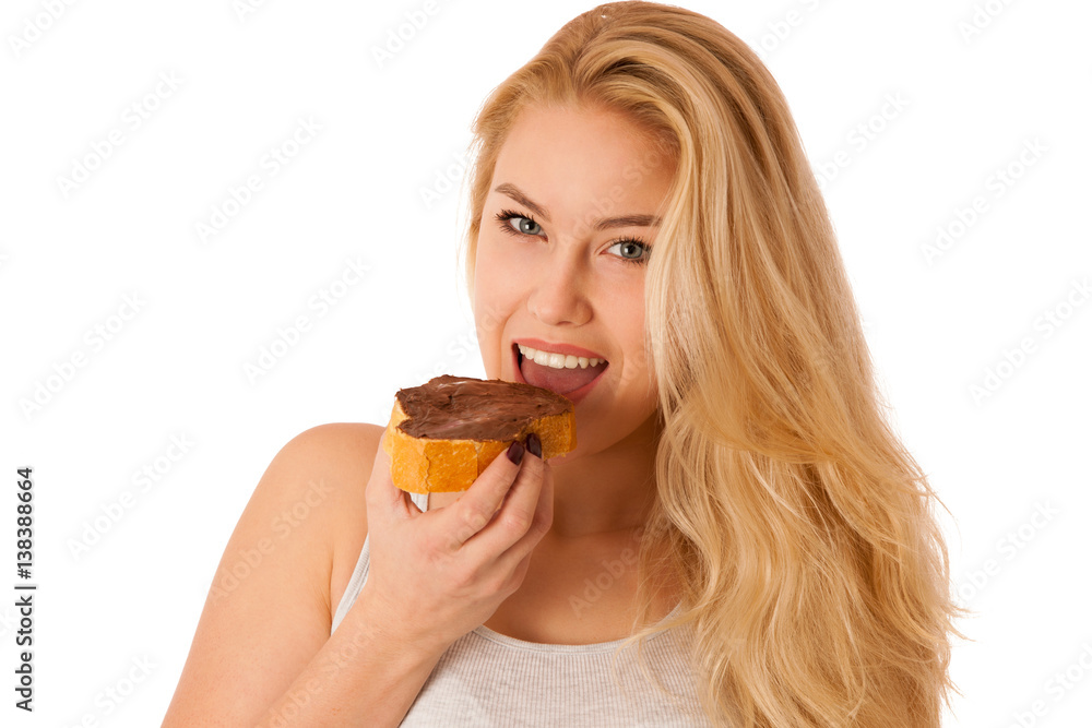 Young blond woman eating breakfast bread and nougat spread isolated over white background Young blond woman eating breakfast bread and nougat spread isolated over white background
