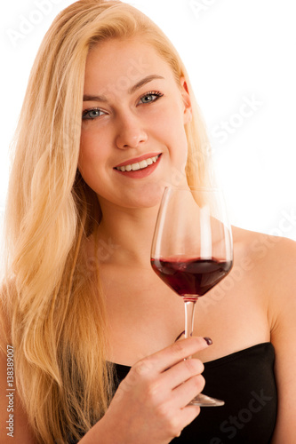Cute blonde woman drinks a glass of red wine isolated over white background