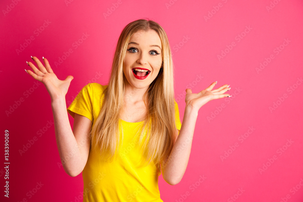 excited young woman over pink background gesture success with arms up in the air excited young woman over pink background gesture success with arms up in the air