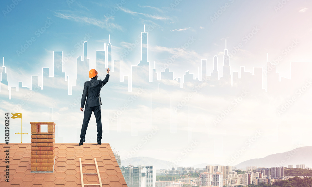 Man architect draw silhouette of modern city on blue sky. Mixed Man architect draw silhouette of modern city on blue sky. Mixed
