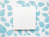 blue and white, square frame on the background leaves. leaves cut from paper