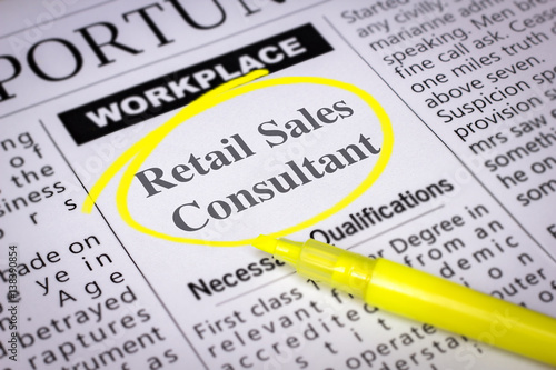 Retail Sales Consultant - Newspaper sheet with ads and job search, circled with yellow marker, Blurred image and selective focus