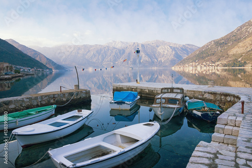 Fishing boats in the small harbor near seaside Stoliv village. Bay of Kotor  Montenegro  winter