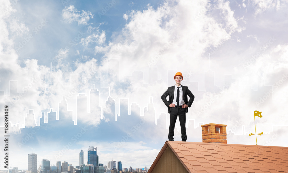 Engineer man standing on roof and looking away. Mixed media Engineer man standing on roof and looking away. Mixed media