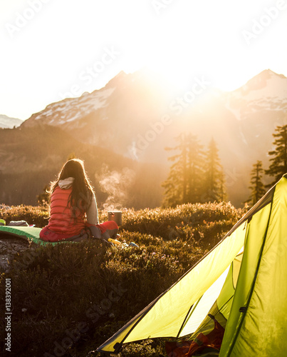 Woman looking at snow capped mountains at sunrise, Elfin Lakes, Canada, British Columbia, North America 