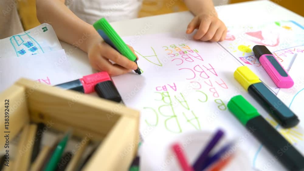 Happy family. Mother and daughter are learning to write. Adult woman teaches child the alphabet. Happy family. Mother and daughter are learning to write. Adult woman teaches child the alphabet.