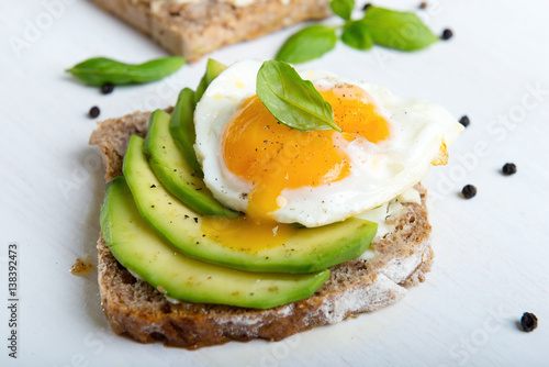Sandwich with avocado slices and basil