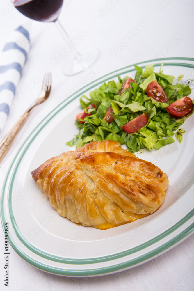 Chicken breast in french pastry with fresh salad Chicken breast in french pastry with fresh salad