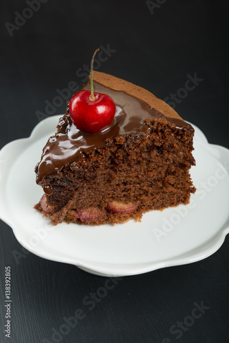 Chocolate cake with juicy cherries photo