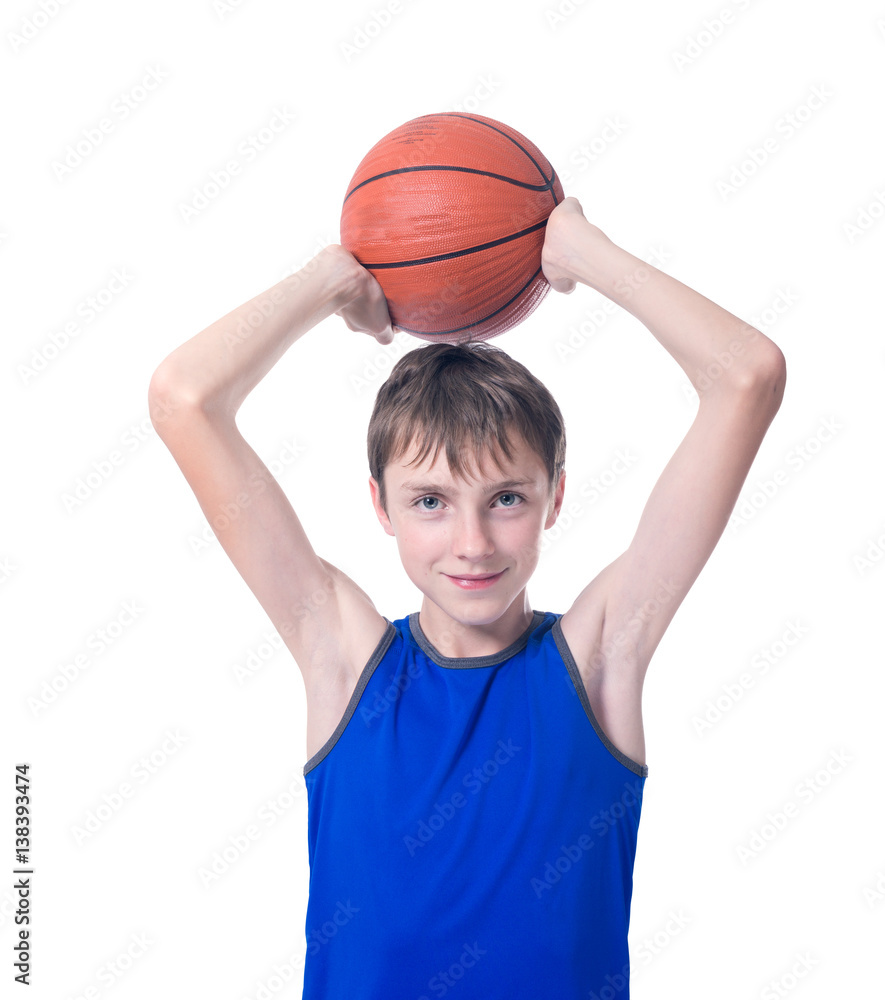 Joyful teenager  holding a ball for basketball over his head. Isolated on white background