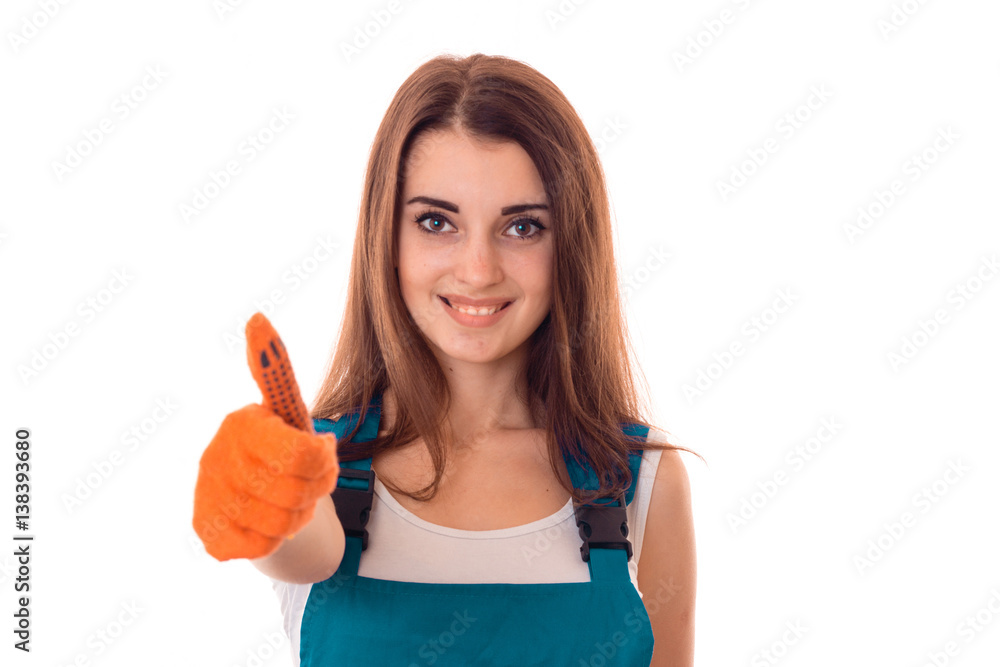 studio portrait of young happy girl in uniform makes renavation and showing thumbs up isolated on white background studio portrait of young happy girl in uniform makes renavation and showing thumbs up isolated on white background