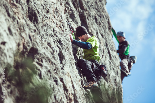 man climbs a rock