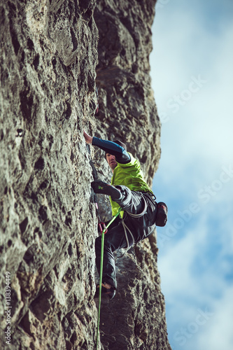 man climbs a rock