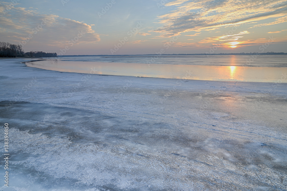 The sun set over the frozen lake
