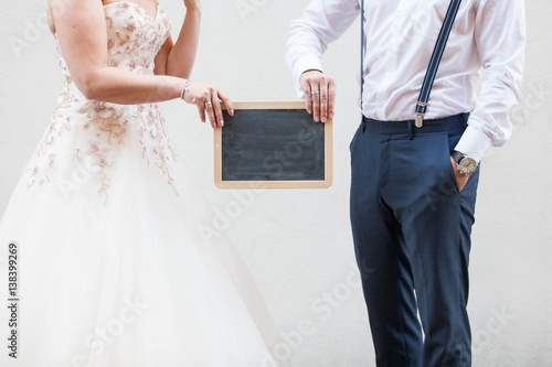 married couple holding a blackboard celebrating wedding marriage
