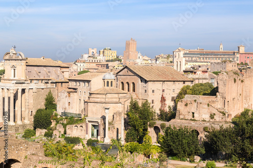 Rome, Italy. Roman Forum: Temple of Antoninus and Faustina (141 AD), Temple of Romulus (307 AD), Church of Santi Cosma e Damiano photo