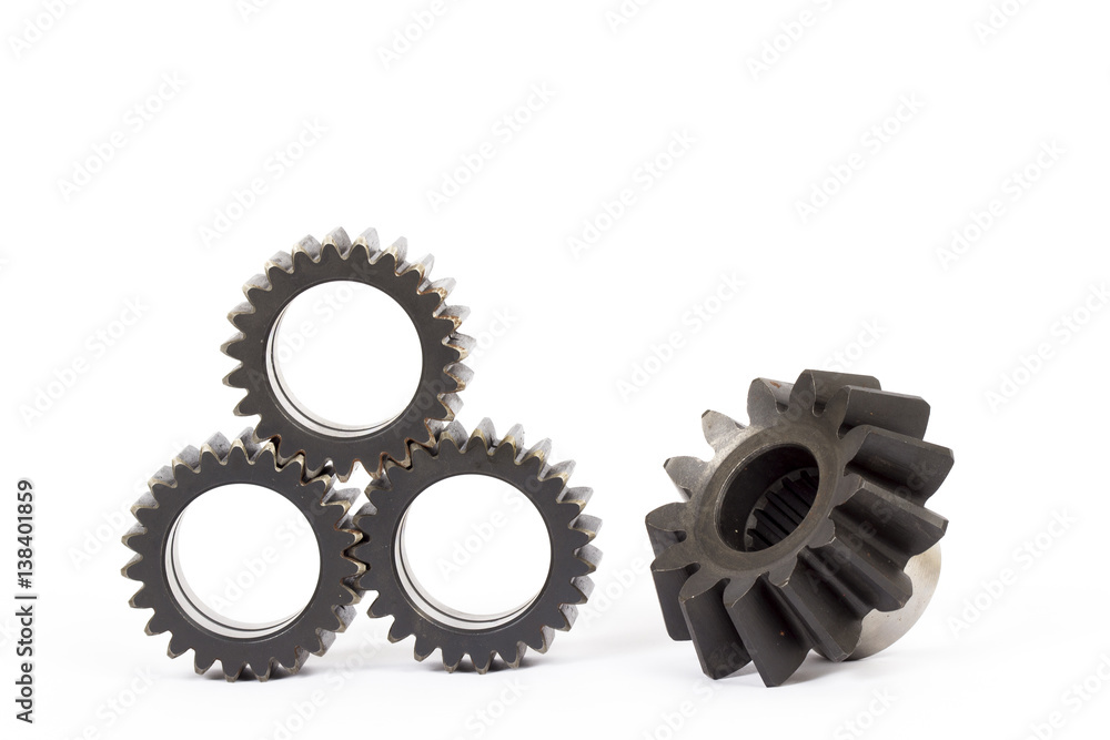Small group of gears with their teeth engaged on a white background. Small group of gears with their teeth engaged on a white background.