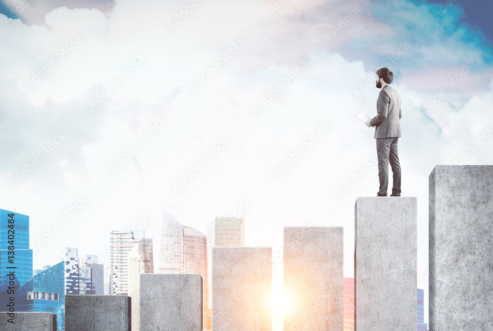 Man standing on bar chart and looking at city Man standing on bar chart and looking at city