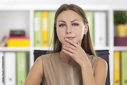 Portrait of a pensive businesswoman in beige