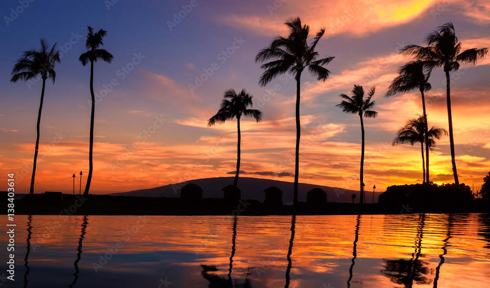 Red hawaiian sunset over pool